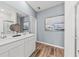 Stylish bathroom with dual sinks, white cabinetry, a large mirror, and modern lighting fixtures at 760 Meadowbrook Ln, Summerville, SC 29486