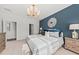 This bedroom features a gorgeous light fixture and a beautifully accent wall at 760 Meadowbrook Ln, Summerville, SC 29486