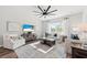 Bright living room with stylish furniture, a large ceiling fan, and a coastal-themed display on the television at 760 Meadowbrook Ln, Summerville, SC 29486