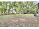 Spacious backyard surrounded by mature trees, provides ample space for outdoor activities at 7674 Chippendale Rd, North Charleston, SC 29420