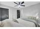 Light-filled bedroom featuring a ceiling fan, white comforter, and access to a stylish, modern closet at 7674 Chippendale Rd, North Charleston, SC 29420