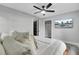 Modern bedroom featuring a sleek ceiling fan, wall-mounted TV, and a door leading to the closet at 7674 Chippendale Rd, North Charleston, SC 29420