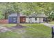 Charming single-story home featuring a cozy front porch, a covered carport, and a well-maintained lawn at 7674 Chippendale Rd, North Charleston, SC 29420