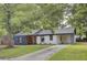 Charming single-story home featuring a cozy front porch, a covered carport, and a well-maintained lawn at 7674 Chippendale Rd, North Charleston, SC 29420