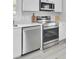 Stainless steel oven and microwave above, complemented by bright white cabinets and counters at 7674 Chippendale Rd, North Charleston, SC 29420