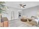 Cozy living room featuring stylish furniture and luxury vinyl plank flooring with a kitchen view at 7674 Chippendale Rd, North Charleston, SC 29420