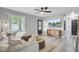 Bright living room featuring stylish furniture and a modern ceiling fan and luxury vinyl plank flooring at 7674 Chippendale Rd, North Charleston, SC 29420