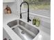 Modern stainless steel sink with matte black faucet and stylish soap dispensers at 7674 Chippendale Rd, North Charleston, SC 29420