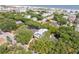 Aerial view of a house with a view of a neighborhood and ocean landscape, surrounded by many green trees at 814 Palm Blvd, Isle of Palms, SC 29451