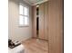 Bright closet featuring hardwood floors, a window, and built in wooden shelves for storage at 814 Palm Blvd, Isle of Palms, SC 29451