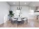 Stylish dining room with a modern chandelier, elegant seating, and plenty of natural light at 814 Palm Blvd, Isle of Palms, SC 29451