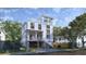 Stunning exterior view of a modern home with a rooftop deck, beautiful balconies, and a charming front porch at 814 Palm Blvd, Isle of Palms, SC 29451