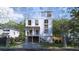 Beautiful three-story home with a charming staircase and a well-manicured lawn at 814 Palm Blvd, Isle of Palms, SC 29451