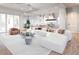 Bright and airy living room featuring a large sectional sofa, modern lighting, and hardwood floors at 814 Palm Blvd, Isle of Palms, SC 29451