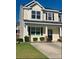 Inviting two-story home featuring black shutters, a covered porch, and manicured landscaping at 9088 Parlor Dr, Ladson, SC 29456