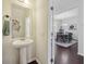 Stylish half bathroom with a pedestal sink and decorative accents near the dining room at 9088 Parlor Dr, Ladson, SC 29456