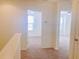 Bright hallway leading to bedrooms with neutral carpet and natural light at 9088 Parlor Dr, Ladson, SC 29456