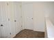 Hallway with doors, white trim, and neutral carpet at 9088 Parlor Dr, Ladson, SC 29456