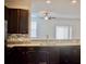 Modern kitchen featuring dark cabinets, stainless steel appliances, and a pass-through to the living area at 9088 Parlor Dr, Ladson, SC 29456