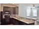 Well-equipped kitchen with dark cabinetry, modern appliances, and a granite countertop at 9088 Parlor Dr, Ladson, SC 29456