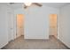 Main bedroom featuring neutral carpet, a ceiling fan, and walk-in closets at 9088 Parlor Dr, Ladson, SC 29456