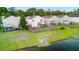 Aerial view of a spacious backyard with lush lawn, fenced perimeter, and a tranquil pond nearby at 9747 Seed St, Ladson, SC 29456