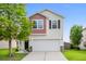Charming two-story home with white siding, brick accents, and an attached two car garage at 9747 Seed St, Ladson, SC 29456