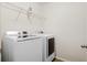 Functional laundry room with washer, dryer, and built-in shelving for storage at 9747 Seed St, Ladson, SC 29456