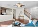 Open-concept living space with hardwood floors, staircase, and view to the kitchen at 9747 Seed St, Ladson, SC 29456