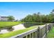 Picturesque pond view with lush greenery, reflecting serene waters and a scenic neighborhood backdrop at 9747 Seed St, Ladson, SC 29456