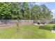 A spacious backyard with a fire pit area, screened-in porch, and well-maintained lawn provides a serene outdoor setting at 9829 English Elm St, Ladson, SC 29456