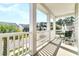 A cozy balcony with seating offers a pleasant view of the neighborhood street at 9829 English Elm St, Ladson, SC 29456