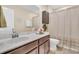 Cozy bathroom featuring vanity with white countertop, framed mirror, and shower with curtain at 9829 English Elm St, Ladson, SC 29456