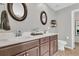 Bright bathroom featuring a double vanity with white countertop, dual sinks, and modern fixtures at 9829 English Elm St, Ladson, SC 29456