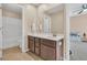 Neutral bathroom includes a large vanity with a mirror and shower with a tub at 9829 English Elm St, Ladson, SC 29456
