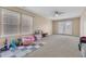 A spacious bonus room featuring neutral carpet, large windows, and light colored walls is ready for your touch at 9829 English Elm St, Ladson, SC 29456