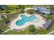 Aerial view of an expansive pool area with ample lounging chairs in a lush landscaped community at 9829 English Elm St, Ladson, SC 29456