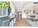 Inviting entryway with wood floors, bench seating, decorative accents, and an open view into the dining area at 9829 English Elm St, Ladson, SC 29456