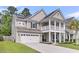 This is a charming two-story home with a two-car garage, a second story porch, and a well-manicured lawn at 9829 English Elm St, Ladson, SC 29456