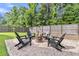 Backyard fire pit area with Adirondack chairs, gravel and fenced yard offers a cozy outdoor retreat at 9829 English Elm St, Ladson, SC 29456