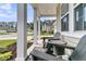Relaxing front porch with two chairs and table with neighborhood view at 9829 English Elm St, Ladson, SC 29456