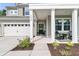 Inviting front porch with craftsman columns, a cozy seating area, and a beautifully landscaped front yard at 9829 English Elm St, Ladson, SC 29456