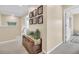 Hallway with carpet flooring featuring decorative trunk with accents and Gathering photos on the wall at 9829 English Elm St, Ladson, SC 29456