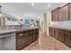 This open concept kitchen features dark cabinets, subway tile backsplash, stone countertops, and stainless appliances at 9829 English Elm St, Ladson, SC 29456