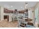 This kitchen offers dark cabinetry, stainless appliances, stone countertops, a breakfast bar, and a eat-in dining area at 9829 English Elm St, Ladson, SC 29456