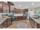 A lovely kitchen featuring granite counters, subway tile backsplash, stainless appliances, and dark cabinets for a luxurious feel at 9829 English Elm St, Ladson, SC 29456