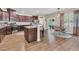 A kitchen with stainless appliances, granite counters, a breakfast bar, a dining area, and a view to the back yard at 9829 English Elm St, Ladson, SC 29456