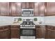 The kitchen features stainless steel appliances, dark cabinets, decorative hardware, and white subway tile backsplash at 9829 English Elm St, Ladson, SC 29456