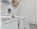 Bright laundry room featuring modern washer and dryer with convenient shelving and storage for cleaning supplies at 9829 English Elm St, Ladson, SC 29456