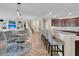 The open concept living space shows the kitchen, dining area, and living room that features built-ins for storage at 9829 English Elm St, Ladson, SC 29456